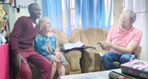 Dr. Prudy and Mr. Thaddeus with a student